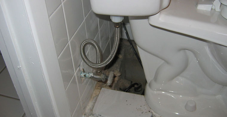 Toilet sitting directly on top of sump pump pit